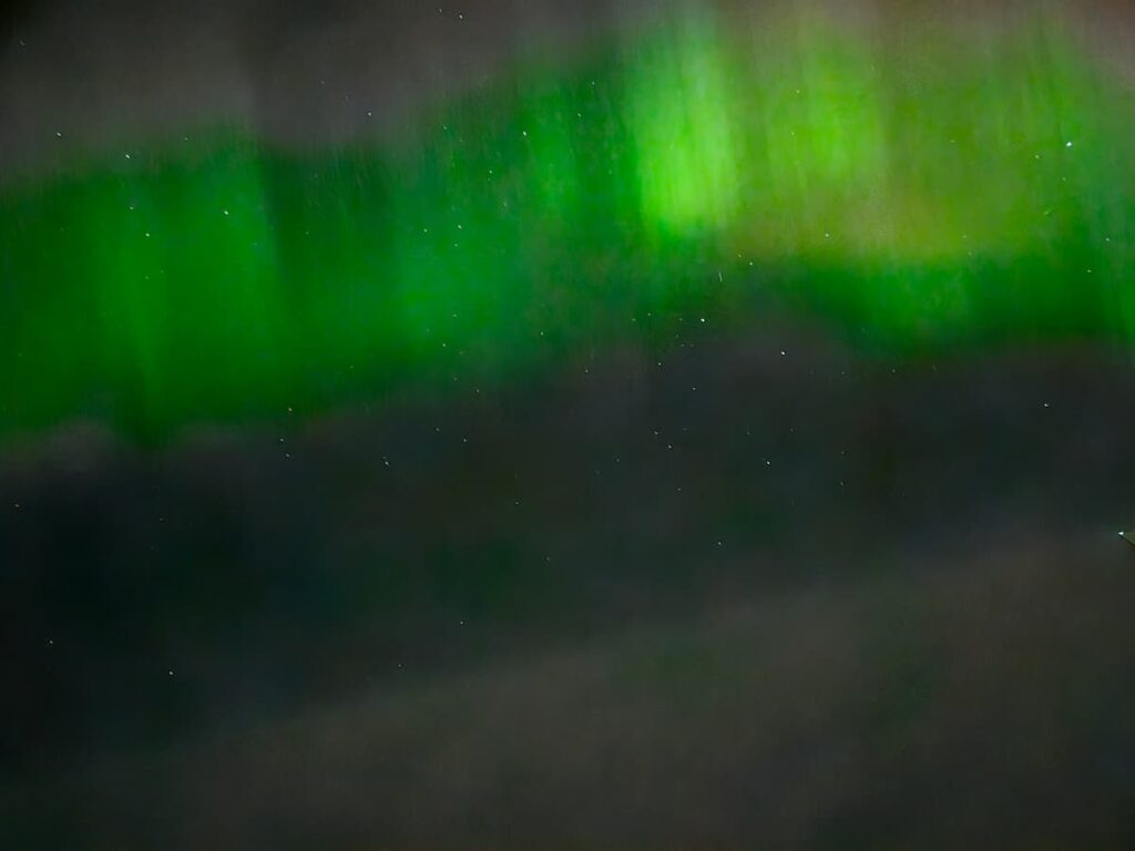Aurora Borealis in bright green, photo taken from a plane