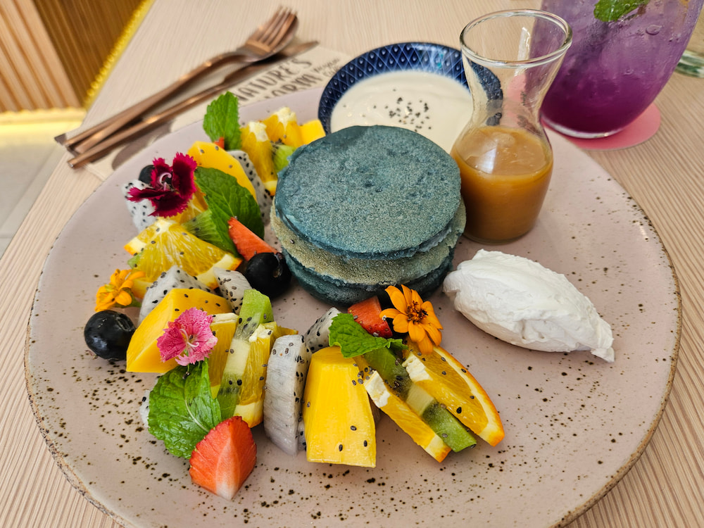 Vegan breakfast in Bangkok, Thailand: Blue pancakes with tropical fruit at Nature's Charm