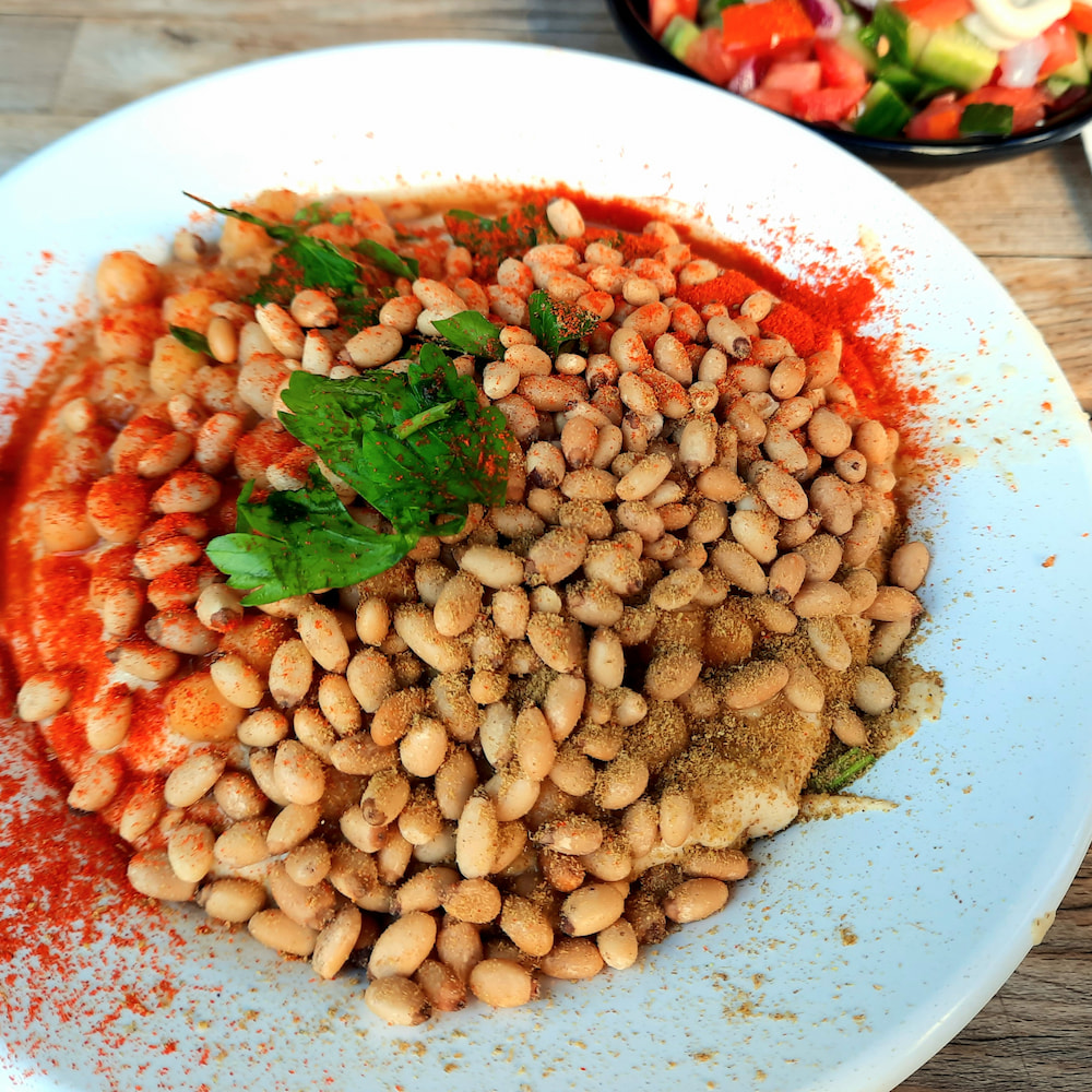 Vegan breakfast in Tel Aviv, Israel: Hummus with pine nuts at Abu Adham